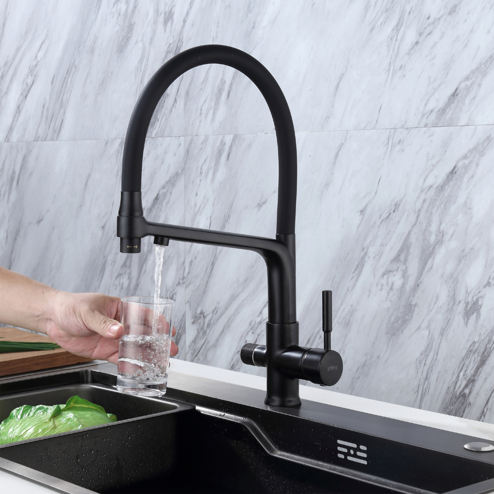 3 way kitchen tap with dual outlets dispensing filtered water into a glass in modern kitchen